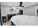 This bedroom offers a ceiling fan, tv, grey walls, and wood-look flooring at 1660 Rose Garden Ln, Loganville, GA 30052