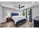 This bedroom offers a ceiling fan, grey walls, and wood-look flooring at 1660 Rose Garden Ln, Loganville, GA 30052