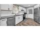 Well-lit kitchen features granite countertops, stainless appliances, and white cabinets at 1660 Rose Garden Ln, Loganville, GA 30052