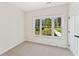 Cozy bedroom with neutral carpet and a bright window offering views of the building across the street at 1995 Deco Dr, Kennesaw, GA 30144