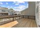 The outdoor deck has a wooden deck surface, metal railings, and partial views of adjacent buildings and clear blue skies at 1995 Deco Dr, Kennesaw, GA 30144