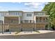 Townhome exteriors with garages and covered decks provide functional outdoor living and modern appeal, set against a treed backdrop at 1995 Deco Dr, Kennesaw, GA 30144
