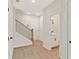 Bright hallway with wood floors, a staircase, access to a half bathroom, and doors to other rooms at 1995 Deco Dr, Kennesaw, GA 30144