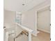 Upstairs hallway with wood floors, leading to a bedroom with ample closet space and view of outside at 1995 Deco Dr, Kennesaw, GA 30144
