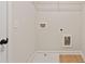 The laundry area features a wire shelf and plumbing connections for appliances, efficient space for laundry needs at 1995 Deco Dr, Kennesaw, GA 30144