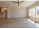 Bright living room featuring hardwood floors, large windows, and a modern ceiling fan at 1995 Deco Dr, Kennesaw, GA 30144