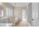 Bright bathroom with large window, soaking tub, double vanity, and separate shower at 3171 Blairhill Ct, Atlanta, GA 30340