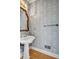 Charming powder room featuring classic fixtures, patterned wallpaper, and hardwood floors at 3171 Blairhill Ct, Atlanta, GA 30340
