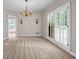 Inviting dining room with elegant chandelier and large windows at 3171 Blairhill Ct, Atlanta, GA 30340