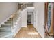 Welcoming foyer with wood floors, staircase with white railing, and view to the formal living at 3171 Blairhill Ct, Atlanta, GA 30340