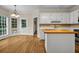 Bright kitchen features white cabinets, a butcher block island, hardwood floors and stainless steel appliances at 3171 Blairhill Ct, Atlanta, GA 30340