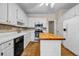 Well-lit kitchen featuring white cabinets, stainless steel appliances, and a butcher block island at 3171 Blairhill Ct, Atlanta, GA 30340