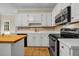 Classic kitchen with white cabinetry, tile backsplash, and a stainless steel range at 3171 Blairhill Ct, Atlanta, GA 30340