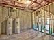 Unfinished basement with concrete floors, exposed ceiling insulation, and dual water heaters against the concrete wall at 3745 Reserve Overlook (#30) Way, Cumming, GA 30041