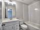 Bright bathroom featuring a white vanity, a large mirror with lighting, and a tiled shower-tub combination at 3745 Reserve Overlook (#30) Way, Cumming, GA 30041