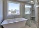 Luxurious bathroom with soaking tub, glass shower and a large window at 3745 Reserve Overlook (#30) Way, Cumming, GA 30041