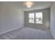 Neutral bedroom with carpeted floors, a ceiling light, and double windows offering natural light and neighborhood views at 3745 Reserve Overlook (#30) Way, Cumming, GA 30041