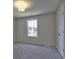 Bedroom featuring neutral walls, carpet, large window, and closet at 3745 Reserve Overlook (#30) Way, Cumming, GA 30041