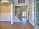 Bright foyer with hardwood floors, a staircase, and a view into other rooms at 3745 Reserve Overlook (#30) Way, Cumming, GA 30041