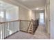 Upstairs hallway featuring wood and iron railing and carpeted floors at 3745 Reserve Overlook (#30) Way, Cumming, GA 30041