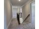 Carpeted hallway with wood banister and bright, neutral walls at 3745 Reserve Overlook (#30) Way, Cumming, GA 30041