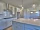 Modern kitchen with white cabinets, stainless steel appliances, and a view into the living area at 3745 Reserve Overlook (#30) Way, Cumming, GA 30041