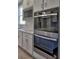 Close up of stainless steel built-in oven and microwave in kitchen with white cabinets at 3745 Reserve Overlook (#30) Way, Cumming, GA 30041