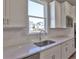 Close-up of kitchen sink and countertop with stainless steel appliances and exterior view at 3745 Reserve Overlook (#30) Way, Cumming, GA 30041
