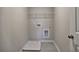 Laundry room featuring gray tile flooring, utility connections, and wire shelving for organized storage solutions at 3745 Reserve Overlook (#30) Way, Cumming, GA 30041