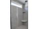 Modern walk-in shower featuring gray tile, built-in shelves and glass door at 3745 Reserve Overlook (#30) Way, Cumming, GA 30041