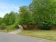 Long driveway leading to a home surrounded by mature trees and lush greenery at 4515 N. Slope Cir, Marietta, GA 30066