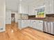Charming kitchen with white cabinets, granite countertops, stainless steel appliances, and hardwood flooring at 4515 N. Slope Cir, Marietta, GA 30066