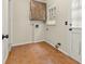 Practical laundry room with tile flooring, storage cabinets, and a window for natural light at 4515 N. Slope Cir, Marietta, GA 30066