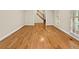 Bright living room with beautiful hardwood floors, large windows, and staircase access at 4515 N. Slope Cir, Marietta, GA 30066