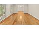 Sunlit living room boasts gleaming hardwood floors and large windows with serene views at 4515 N. Slope Cir, Marietta, GA 30066