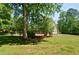 Lush backyard with a well-maintained lawn and mature trees providing natural shade at 5800 Villa Rica Hwy, Dallas, GA 30157