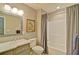 The bathroom features a granite countertop vanity, a toilet, and a shower with neutral-toned walls at 5800 Villa Rica Hwy, Dallas, GA 30157