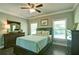 Cozy bedroom featuring a ceiling fan, hardwood floors, and a comfortable bed with bright, natural light at 5800 Villa Rica Hwy, Dallas, GA 30157