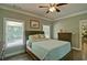 Well-lit bedroom featuring hardwood floors, a comfortable bed, and a ceiling fan at 5800 Villa Rica Hwy, Dallas, GA 30157