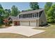 Beautiful two-story home with three-car garage, carriage and gray siding and blue shutters at 5800 Villa Rica Hwy, Dallas, GA 30157