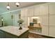 A kitchen island with countertop and cabinetry paired with a built-in workspace and stainless appliances at 5800 Villa Rica Hwy, Dallas, GA 30157