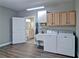 Well-organized laundry room featuring modern appliances, cabinetry, and access to an adjacent bathroom at 5800 Villa Rica Hwy, Dallas, GA 30157