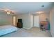 Spacious carpeted main bedroom with a ceiling fan, TV, and an office desk setup at 5800 Villa Rica Hwy, Dallas, GA 30157