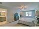 Bright main bedroom features a ceiling fan and a doorway to a bathroom with a marble sink and vanity at 5800 Villa Rica Hwy, Dallas, GA 30157