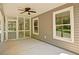 Inviting screened-in porch with windows and ceiling fan offer relaxation and view of backyard at 5800 Villa Rica Hwy, Dallas, GA 30157