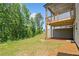 Sloped backyard with partial view of wood deck; natural surroundings add to the property's appeal at 1225 Westshore Dr, Cumming, GA 30041