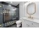 Modern bathroom features a marble shower, a designer mirror, and gold hardware at 1225 Westshore Dr, Cumming, GA 30041