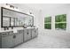 Bathroom with a double vanity, marble floors, and windows providing natural light at 1225 Westshore Dr, Cumming, GA 30041