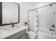 Bathroom with marble tiled walls, a bathtub, shower, and modern vanity at 1225 Westshore Dr, Cumming, GA 30041