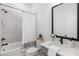 Bathroom features a shower-tub combo, modern vanity, and neutral finishes at 1225 Westshore Dr, Cumming, GA 30041